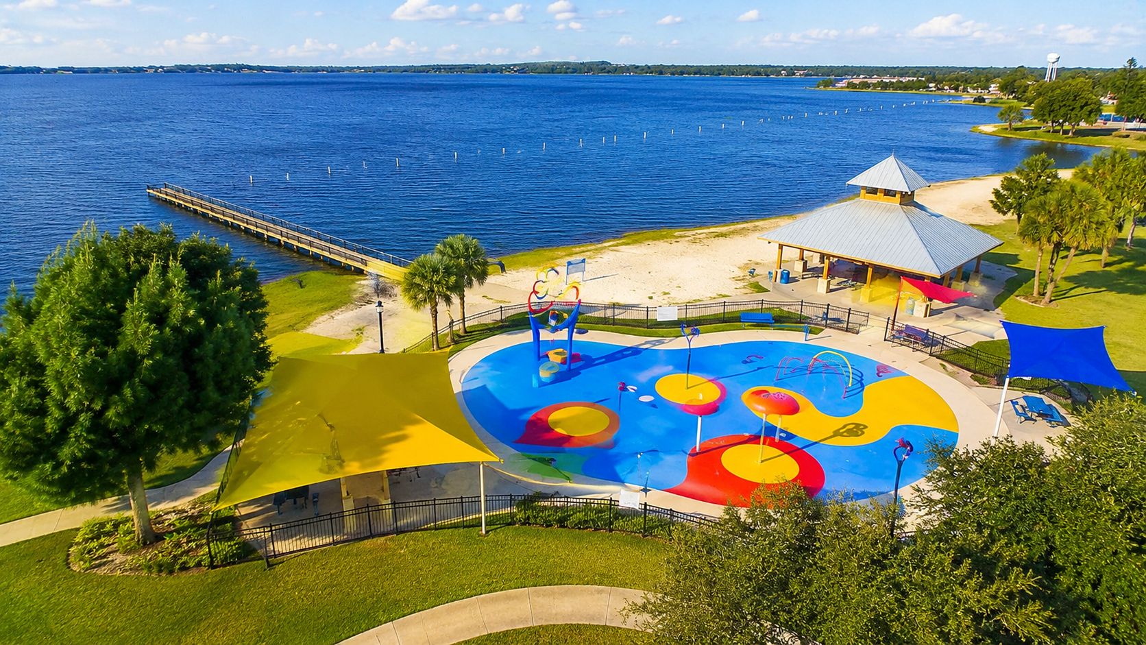 Moving to Clermont FL recreation highlights showcasing the scenic lake views and pavilions at Waterfront Park, by Cheer Alvarez.
